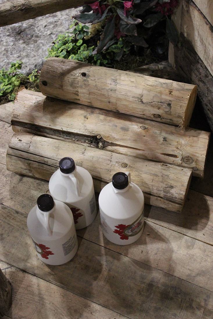 Maple syrup bottles and logs in Ontario